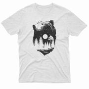 A grayscale graphic of a bear’s profile filled with a double exposure of a pine forest under a full moon.
