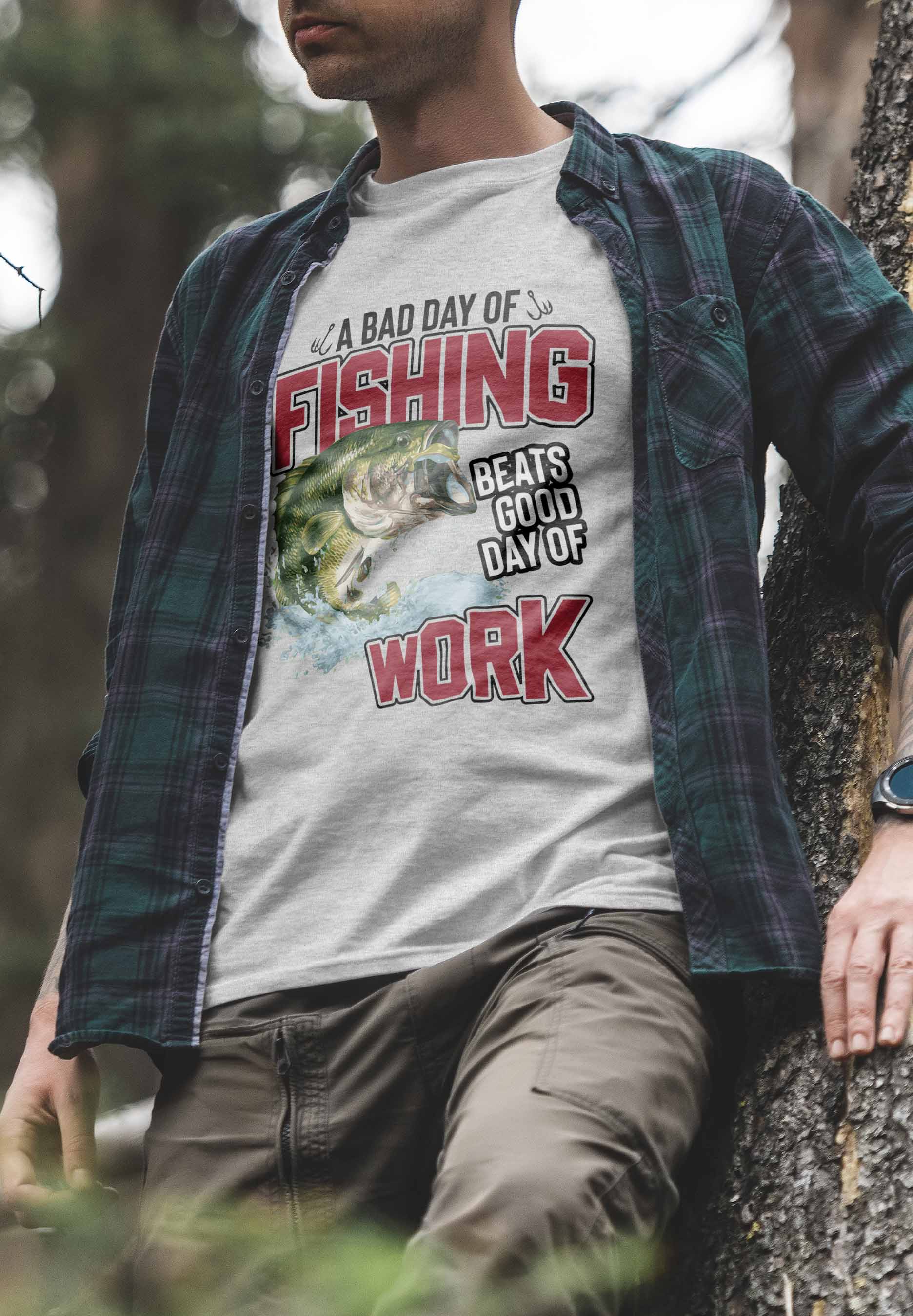 The image features a t-shirt design with the phrase "Fishing Beats Good Day of Work" in bold red letters at the top and bottom. The central graphic is a colorful, detailed illustration of a large green bass leaping out of blue water, capturing the energy and excitement of fishing.