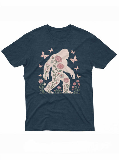 A silhouette of Bigfoot filled with illustrated pink flowers and green stems, surrounded by pink butterflies.