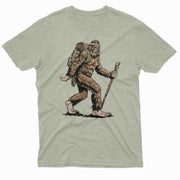 Bigfoot hiking with backpack and walking stick graphic on light green t shirt