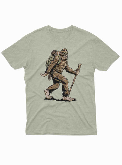 Bigfoot hiking with backpack and walking stick graphic on light green t shirt