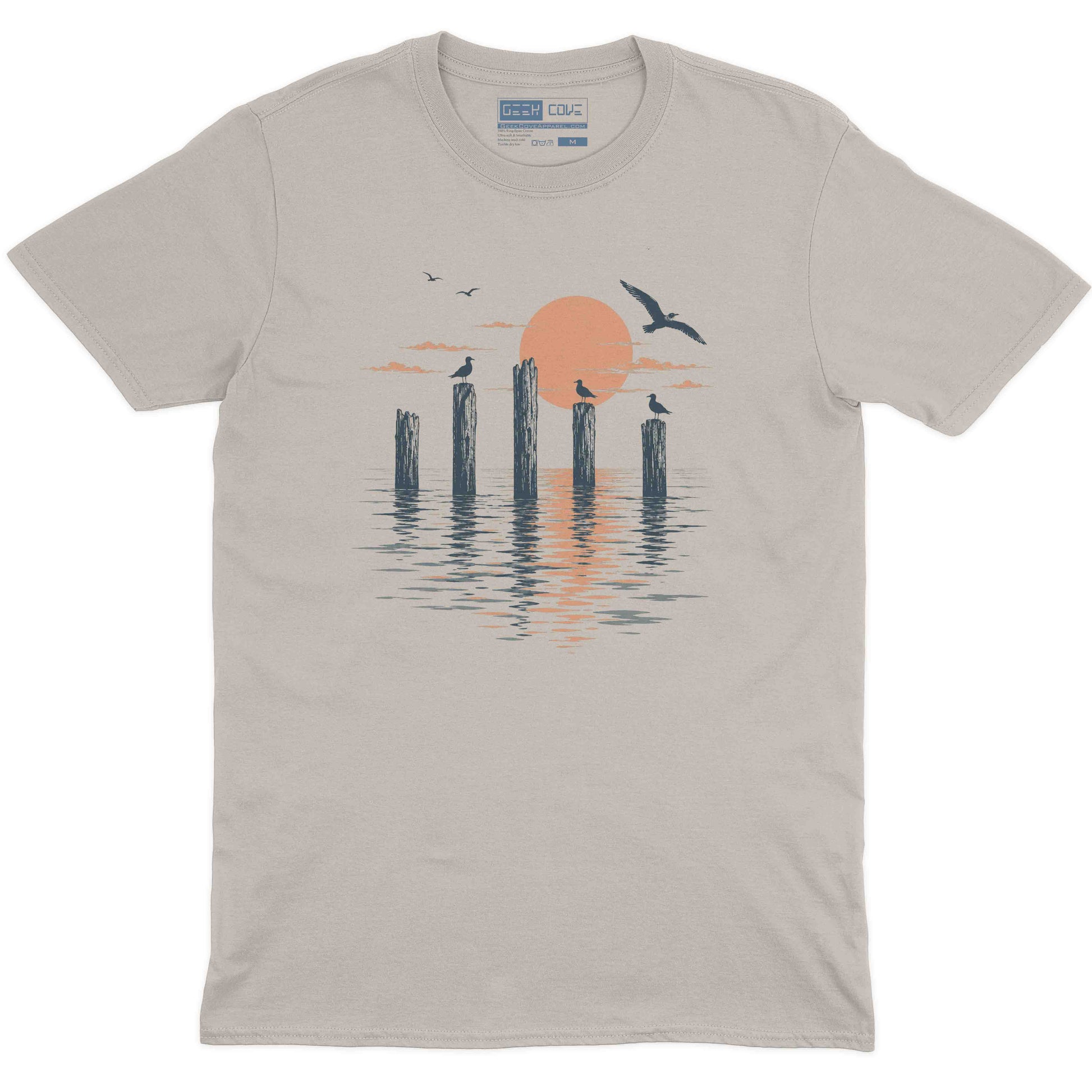 Coastal men graphic tee featuring wooden pilings, flying birds, and a peach sunset