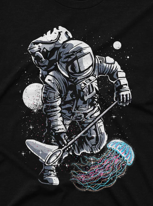 The image depicts a t-shirt design featuring an astronaut in a spacesuit, fishing in space. The astronaut is reeling in a vibrant, colorful jellyfish that looks both ethereal and luminescent against a backdrop of stars.