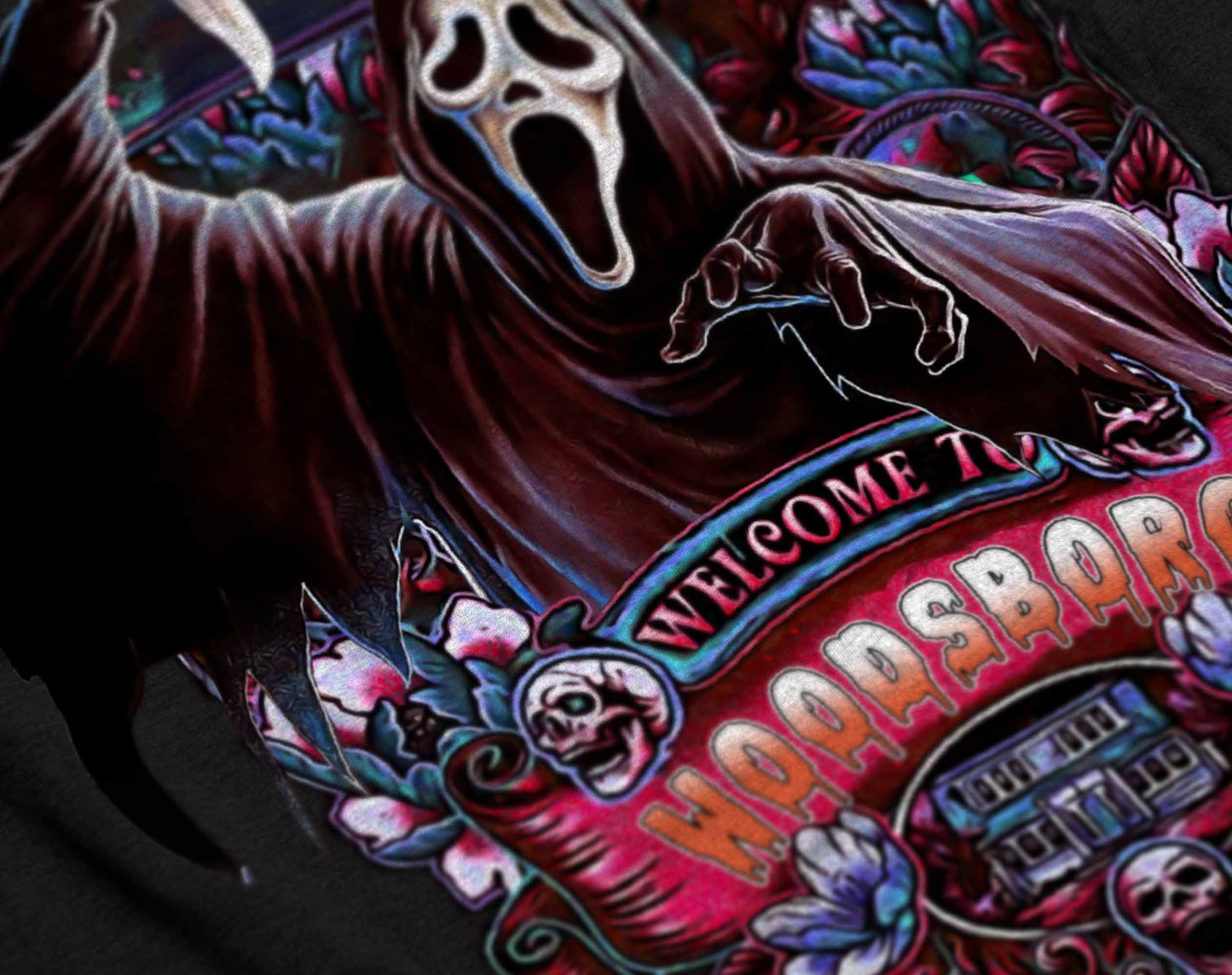 black t-shirt with a detailed illustration of ghostface from scream, featuring colorful floral designs and the text 'welcome to woodsboro'