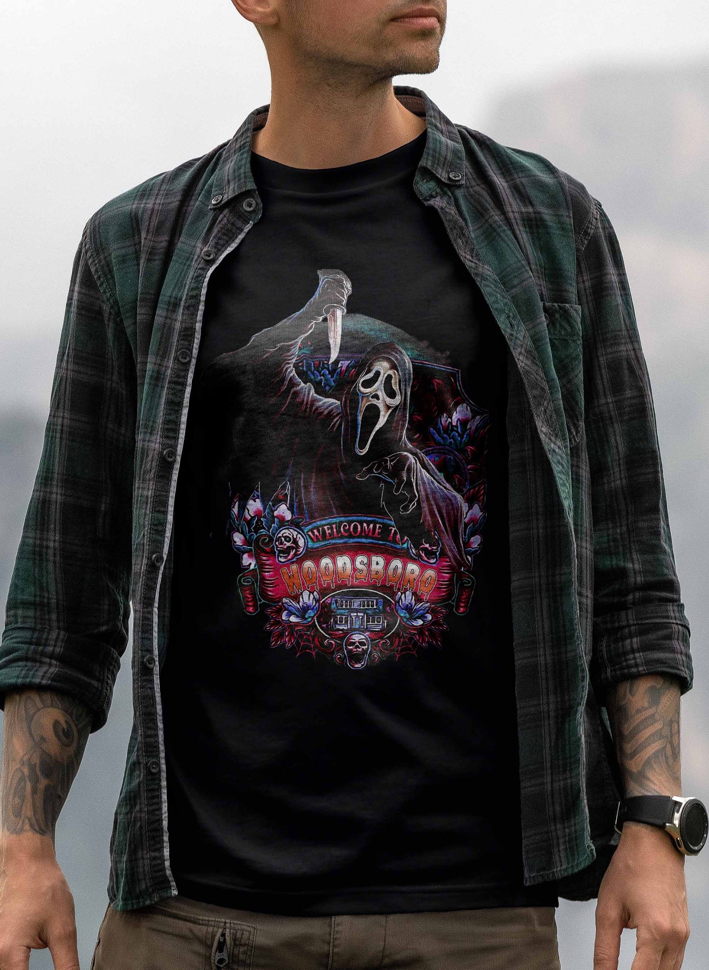 graphic t-shirt with ghostface in a haunting pose, set against a dark, detailed background with themed decorations and woodsboro text.