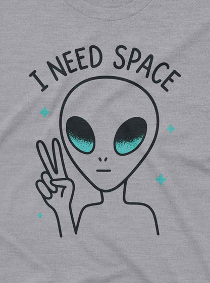 A simple gray t-shirt featuring a cartoon alien making a peace sign with the text “I Need Space.”