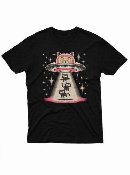 Whimsical illustration of a UFO shaped like a giant cat head abducting three black cats, printed on a black T-shirt.
