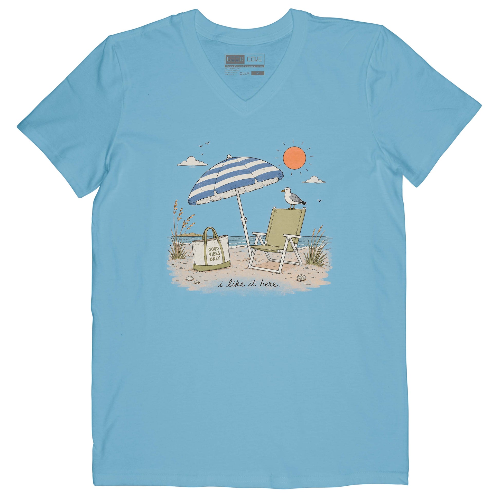 Women’s beach tee shirt with blue striped umbrella, green chair, ocean waves, and sandy shore.