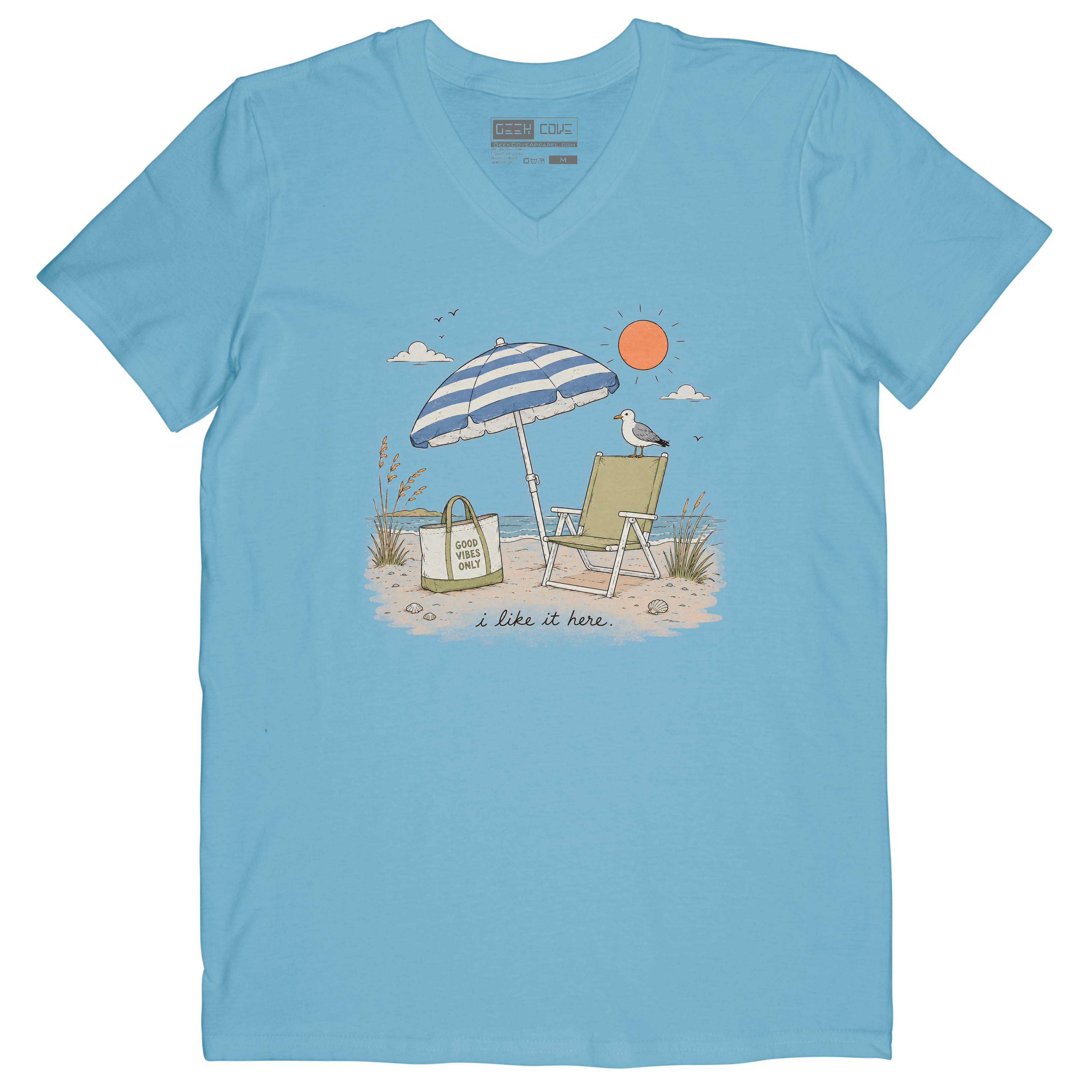 Women’s beach tee shirt with blue striped umbrella, green chair, ocean waves, and sandy shore.