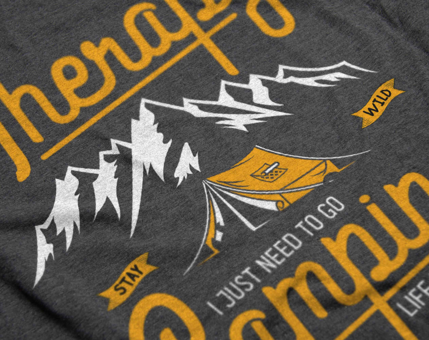 the graphic on the t-shirt presents a playful yet expressive message about camping as therapy. it features large, yellow script with the phrases about not needing therapy but camping instead, accompanied by an illustration of a tent amidst mountain peaks, symbolizing the serenity and adventure found in nature.