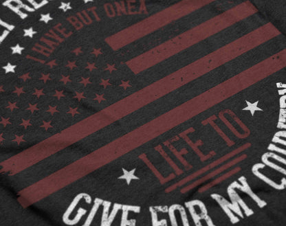 The graphic on the t-shirt presents an American flag in a vintage style, with the quote "I Only Regret That I Have But One Life to Give for My Country" written in an arc above and below the flag. This design pays homage to patriotic sacrifice and is rendered in a way that evokes a sense of historical significance.