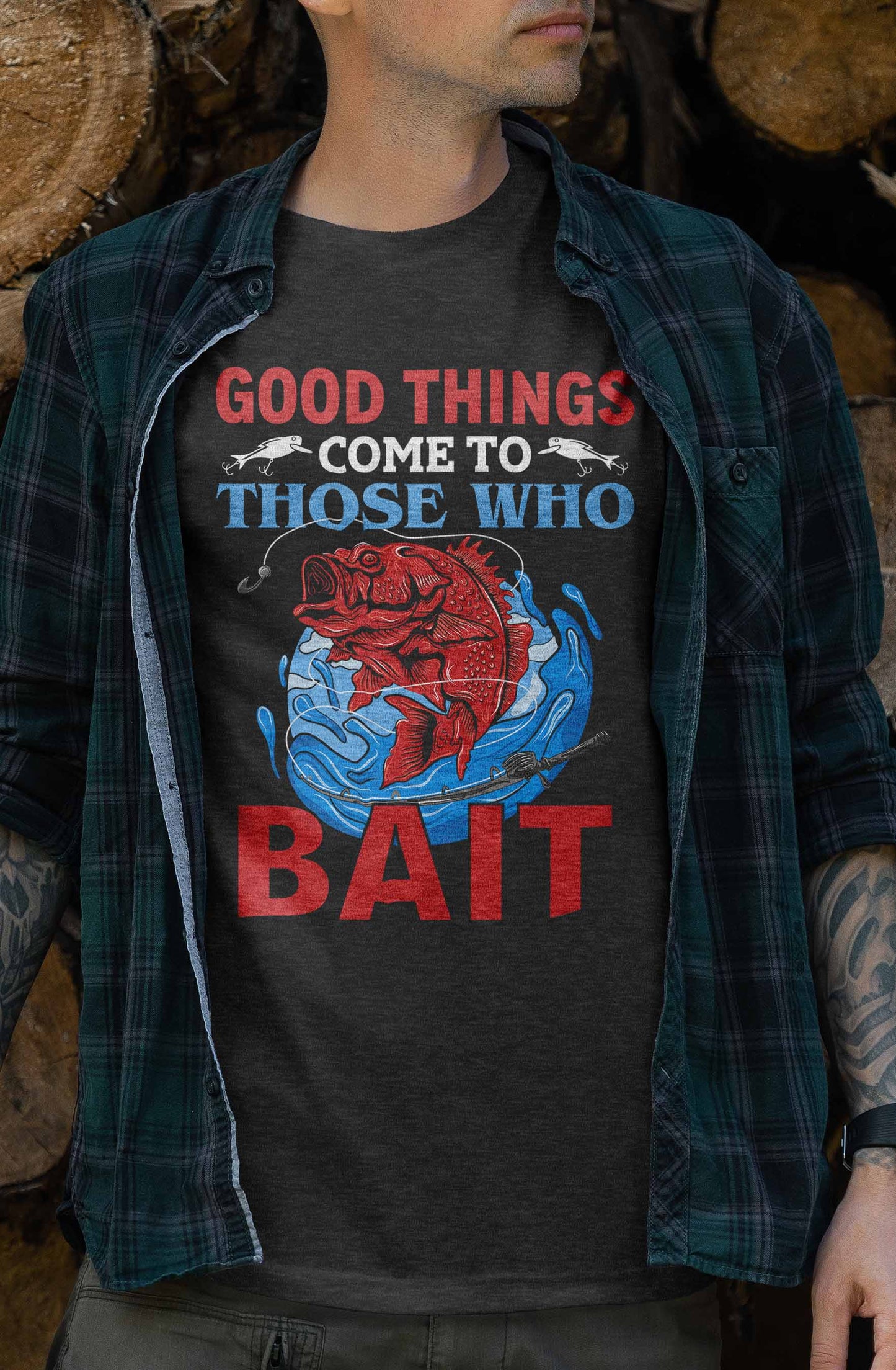 a t-shirt design showcases a striking red fish caught on a lure with the phrase "good things come to those who bait" above in large, eye-catching letters. the graphic emphasizes the thrill of fishing and the virtue of patience.