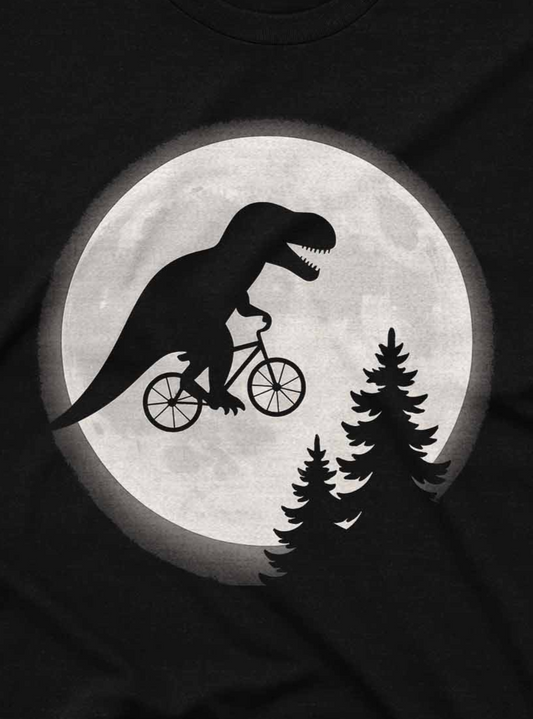 Comical dinosaur riding a bike across a moonlit forest landscape on a black cotton shirt.