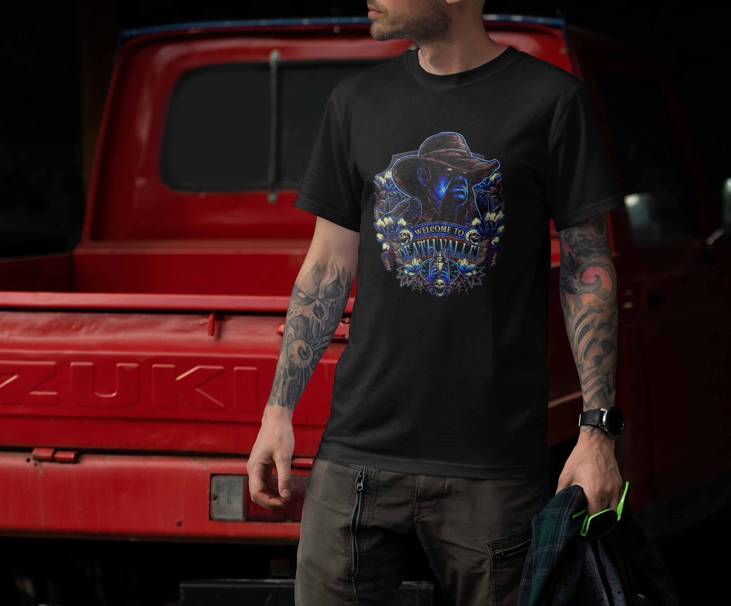 halloween-themed t-shirt with a chilling cowboy in neon blue, set against a black background with halloween-inspired motifs.