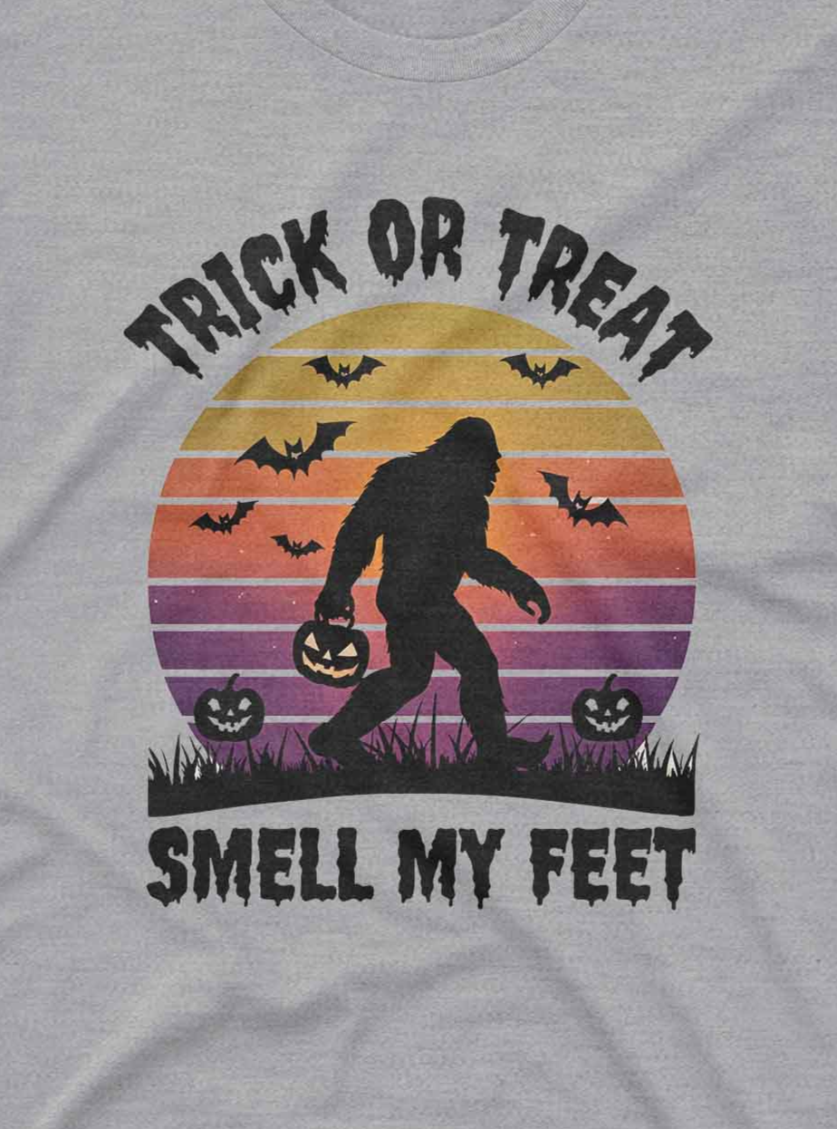 “Vintage style custom tee shirt featuring Sasquatch, pumpkins, bats, and Halloween sunset”
