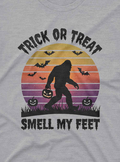 “Vintage style custom tee shirt featuring Sasquatch, pumpkins, bats, and Halloween sunset”