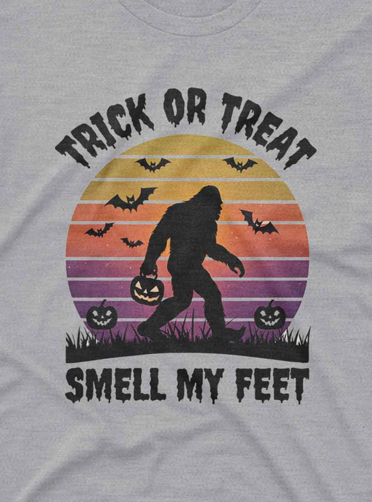 “Vintage style custom tee shirt featuring Sasquatch, pumpkins, bats, and Halloween sunset”