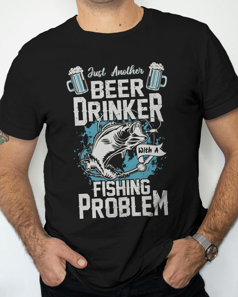 a humorous t-shirt design where the top reads "just another beer drinker," followed by an illustration of a fish jumping towards a fishing lure, and the bottom text stating "with a fishing problem". the design is detailed, emphasizing both the fishing hook and splashing water, aimed at those who enjoy fishing and a good beer.